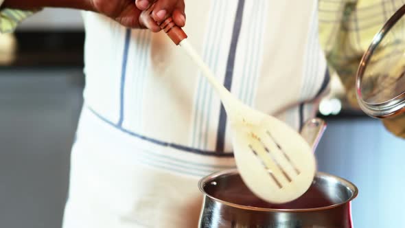 Senior man preparing food in kitchen alt