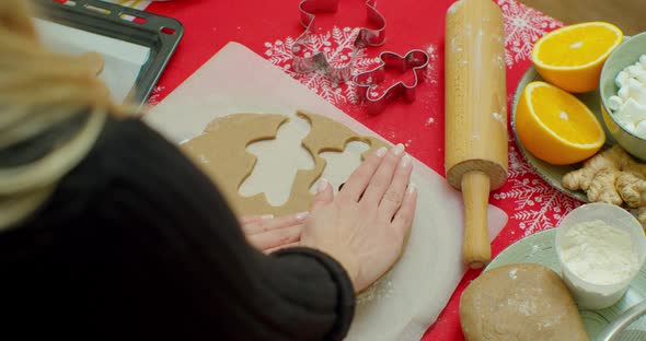 Cutting Out Gingerbread Cookies From Dough in Kitchen, Medium. alt