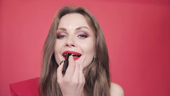 Young Girl Holding Red Lipstick and Finishing Her Makeup