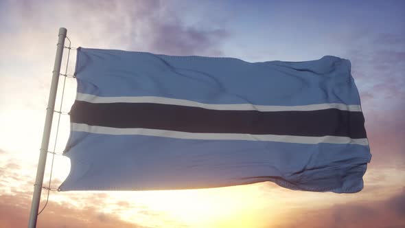 Flag of Botswana Waving in the Wind Sky and Sun Background alt