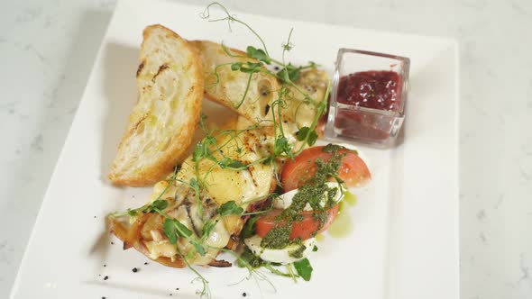 Breakfast on a Plate Omelet with Tomatoes and a Piece of Toast on a Plate Closeup alt