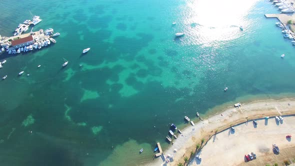 Aerial view of traditional dalmatian town with fishing boats at docks, Croatia alt