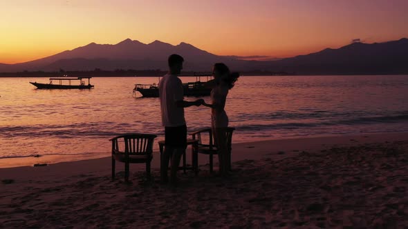 Man and lady posing on perfect bay beach lifestyle by aqua blue water with white sand background of  alt