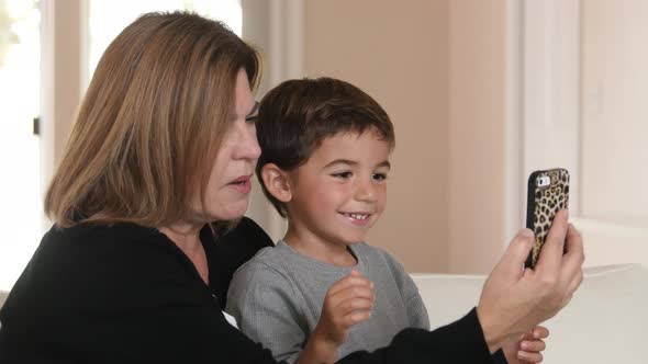 Mother and Son using cell phone together