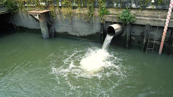 Waste water flows from pipe into a drain channel alt