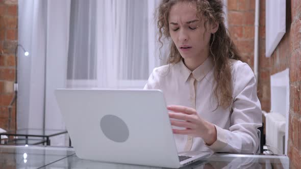 Young Female Upset by Loss while Working on Laptop alt