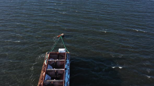 An aerial view over Hempstead Bay during a windy, winter day. The drone camera dolly in, tilt down a alt