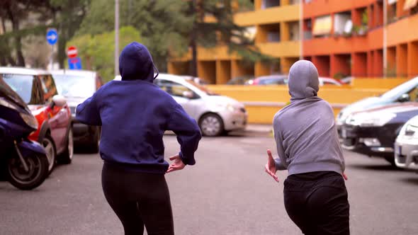 street dance - synchronized ballet of two girls in the hip hop style alt