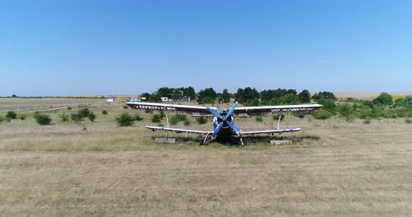 4K aerial video of an old broken abandoned airplane. Flying over alt