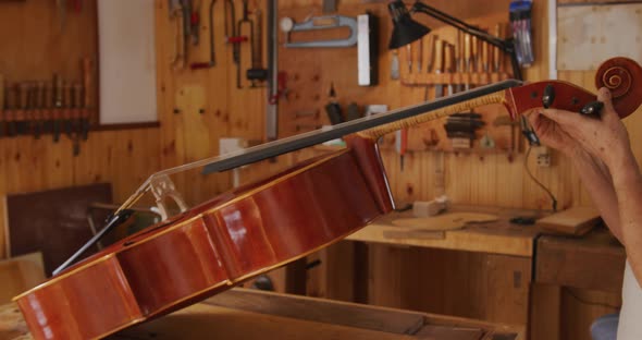 Female luthier at work in her workshop alt