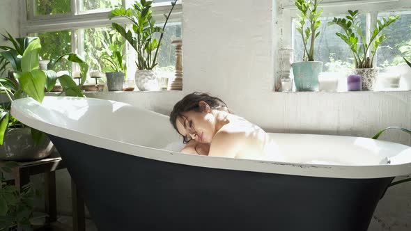 Woman relaxing in the bathtub.