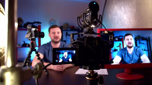 Blogger is Broadcasting in Video Studio with Cameras and Professional Lighting