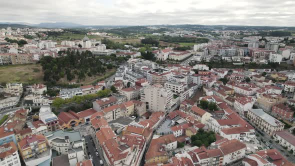 Drone flying over roofs of Leiria residential houses in Portugal. Aerial forward