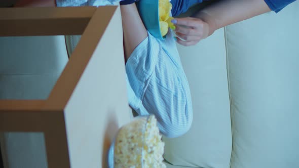 Vertical Video: Speaking on Phone Holding Snacks Bowl alt