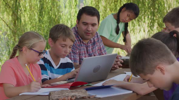 Kids at outdoor school using laptop computer