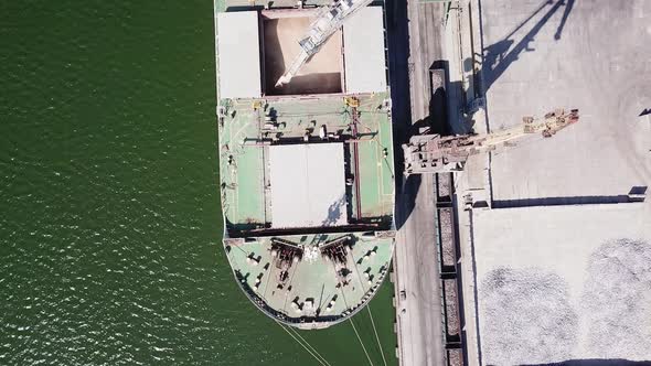 the Camera Looks Vertically Downward As It Flies Over a Seagoing Vessel Moored in the Port Under