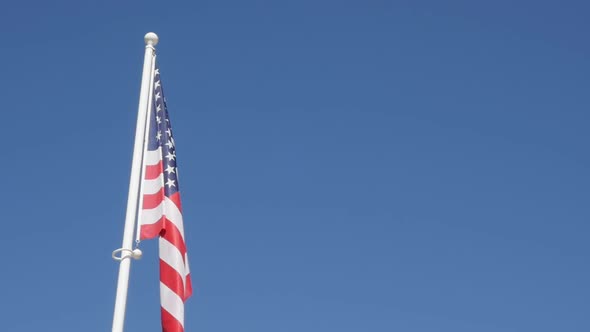 United States of America  flag in front blue sky slow waving on wind 1080p FullHD slow-mo footage - 