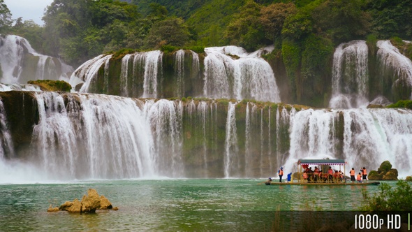 Panoramic Ban Gioc Waterfall In Vietnam With Boat of Tourists alt