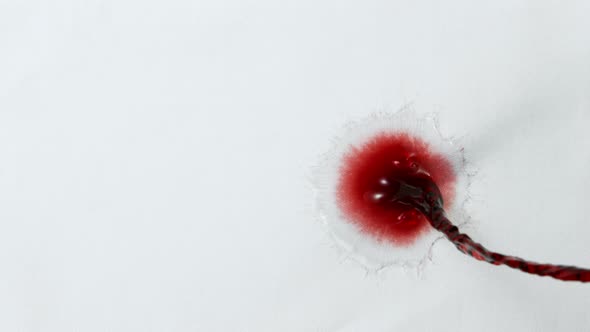 Super Slow Motion Top Shot of Splashing Red Wine on White Cloth at 1000Fps alt