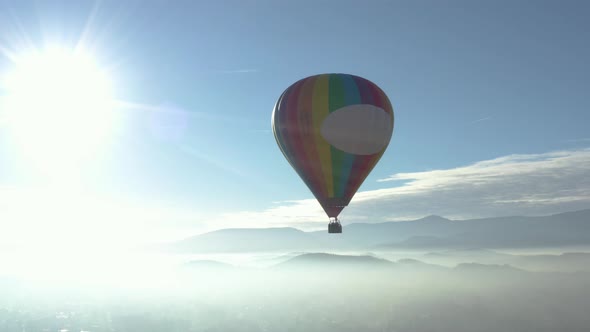 Baloon Flying Over The Clouds