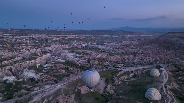 4K Aerial view of Goreme. Colorful hot air balloons fly over the valleys. alt