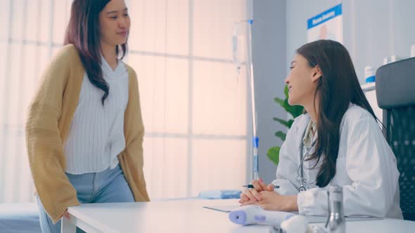 Asian woman patient visit and consult health problem with young doctor. alt