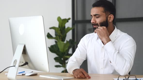 Overworked Frustrated Indian Businessman Manager Sitting at a Desk in ...