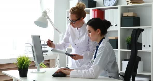 Female Doctors Working with Documents in the Office