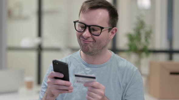 Portrait Man Excited By Online Shopping Success Smartphone alt