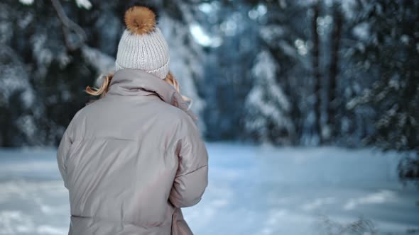 Pleasant Casual Happy Woman with Waving Hair Walking at Winter Forest alt