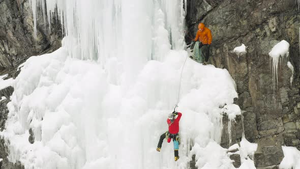 Two extreme mountain climbers scale frozen cascade Maineline, Mount Kineo alt