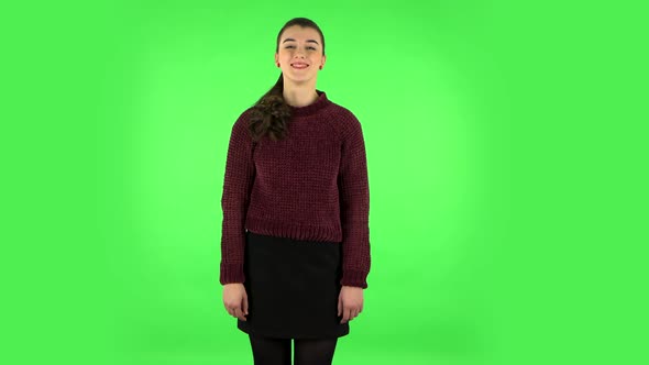 Lovely Girl Smiles Seductively and Winks. Green Screen alt