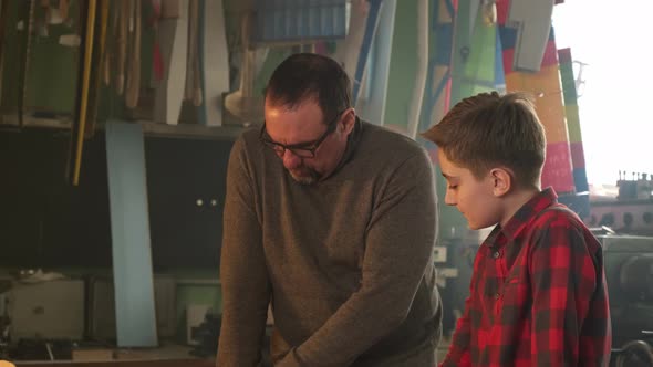 The Teacher Helps the Student to Understand the Drawings alt