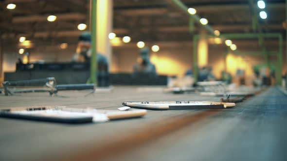 Garbage Moving on a Conveyor While People Sort It for Recycling alt