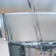 Hot water pouring in glass water slow motion 