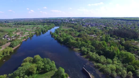 Old dam in countryside. Aerial view of dam on the big river alt