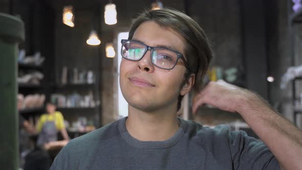 The Guy in the Pottery Workshop Poses for the Camera alt