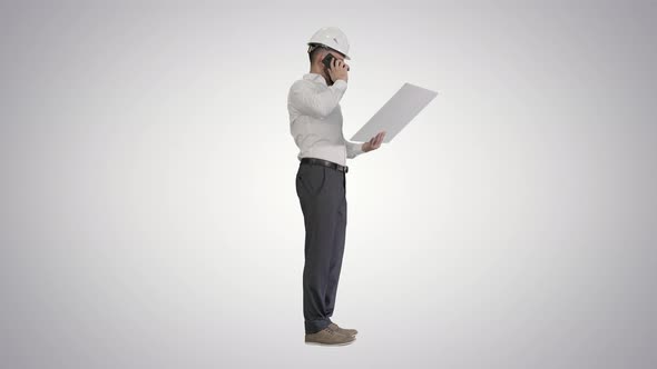 Engineer in Formalwear and Hardhat Talking To Client or Contractor on Mobile Phone and Looking at alt