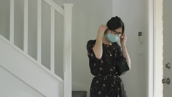 Business woman leaving house for work with mask during lockdown alt
