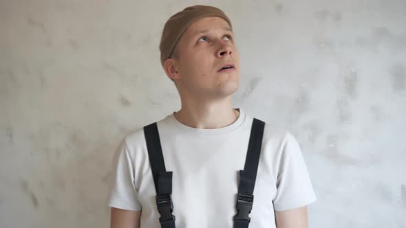 The Painter Shows the Paint Roller and Brush To the Camera Ready To Get To Work alt