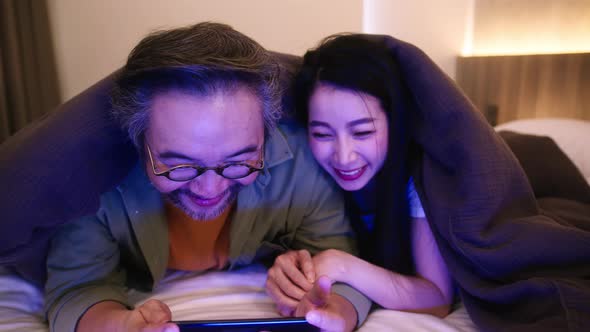 marry couple exited watching horror ghost online movie broadcast from laptop alt