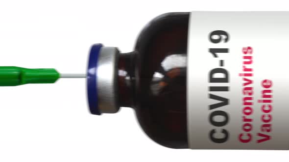 Covid Vaccination Syringe Being Filled alt