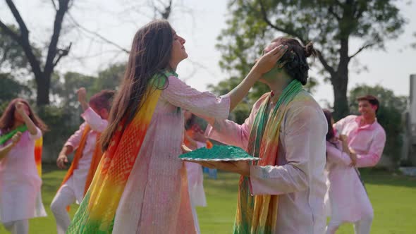 Indian people playing Holi and dancing alt