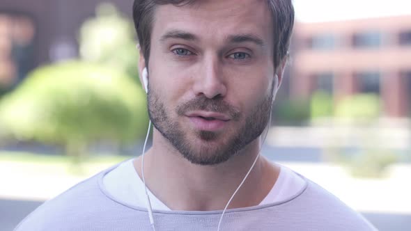 Online Video Chat by Man Standing Outside Office, Talking alt