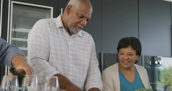 Happy senior diverse people cooking in kitchen at retirement home alt