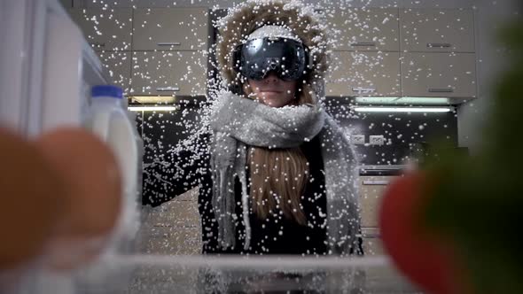 Beautiful young girl in winter clothes and snowboarding goggles stands in the snow