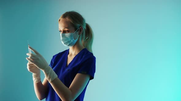 Medium Closeup Studio Shot of a Young Caucasian Female Doctor in Protective Gear Face Mask White alt