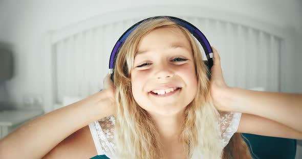 Girl in Headphones in Bed Having Fun