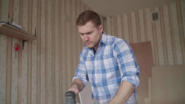 Carpenter Uses a Grinding Machine to Align