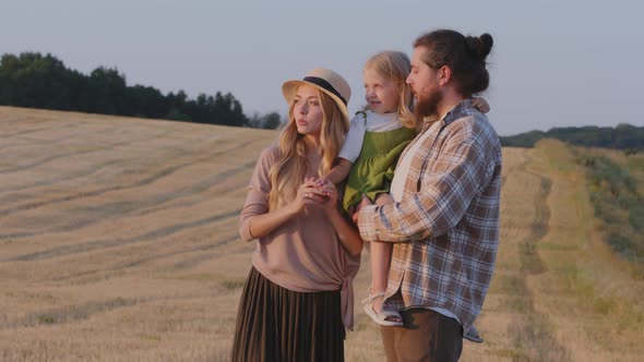 Caucasian Farmers Family Stands in Wheat Field Looks at Horizon Rural Nature Landscape alt